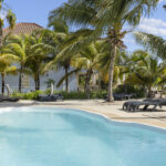Pool surrounded by palm trees, Ocean Breeze Bonaire